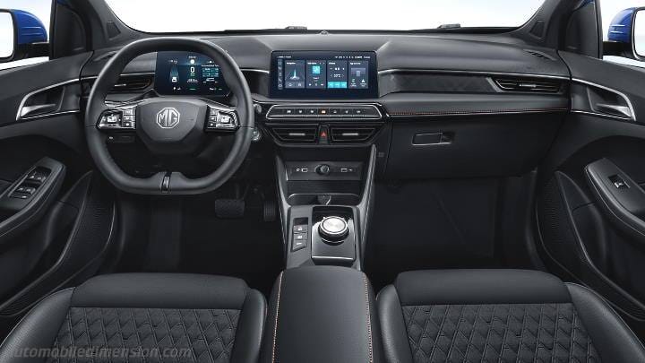 Inside a modern car cabin with a multifunction steering wheel, digital instrument cluster, wide central touchscreen, and quilted black seats.